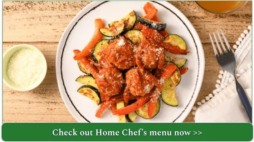 plate of meatballs with roasted red peppers, zucchini and parmesan