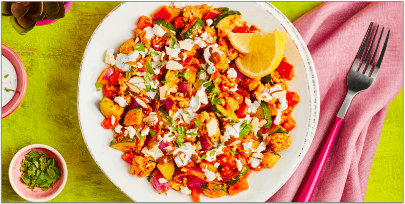 A colorful plate of turkey and vegetables