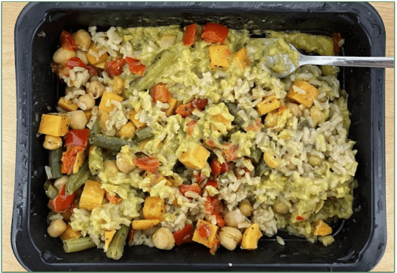 Photo of Factor's Thai Roasted Vegetable Green Curry cooked in a microwaveable tray with a fork ready to eat