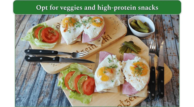 Snack trays of veggies, eggs, ham, and pickles