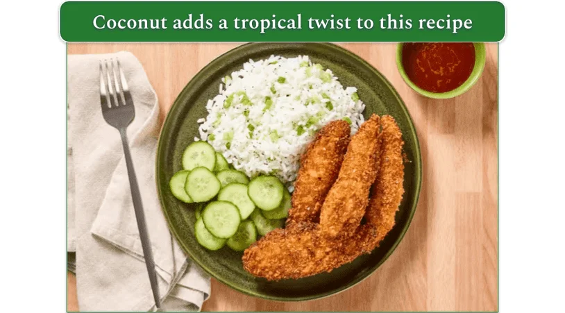 Chicken tenders served with rice and pickled cucumber slices