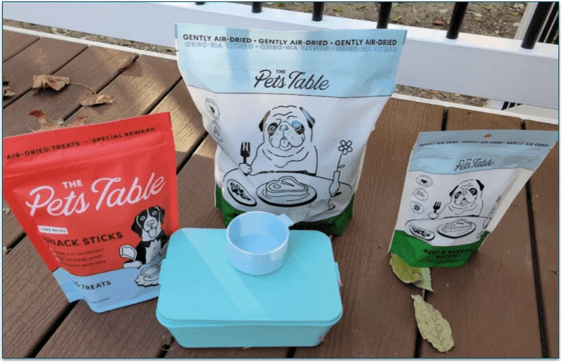 The Pets Table food pouches and a reusable scoop and container