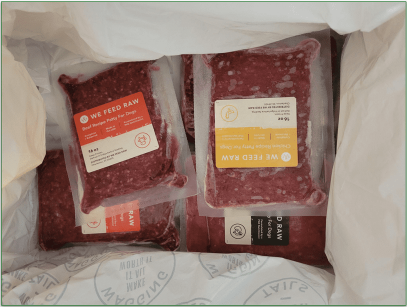 Our reviewers delivery box showing the We Feed Raw food containers packed and frozen
