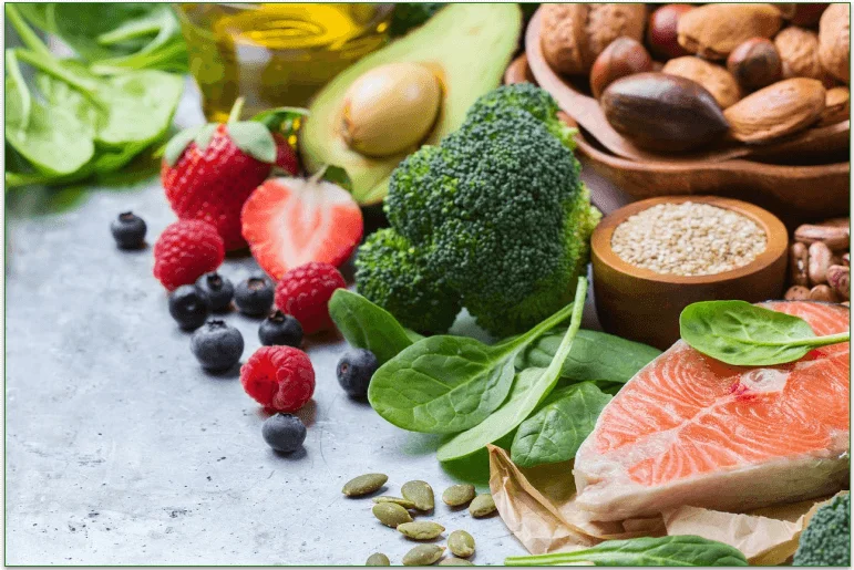 Selection of healthy foods including berries, nuts, vegetables, and fish