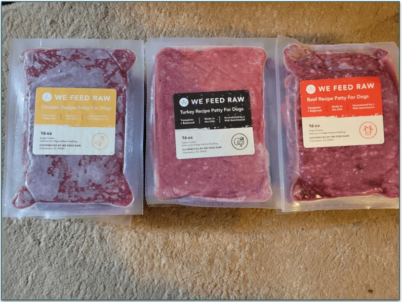 Three stacks of frozen We Feed Raw recipes