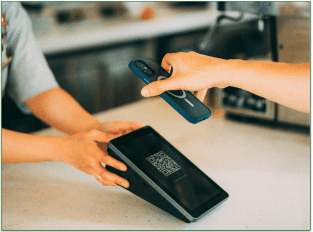 Someone paying for their purchase with their phone