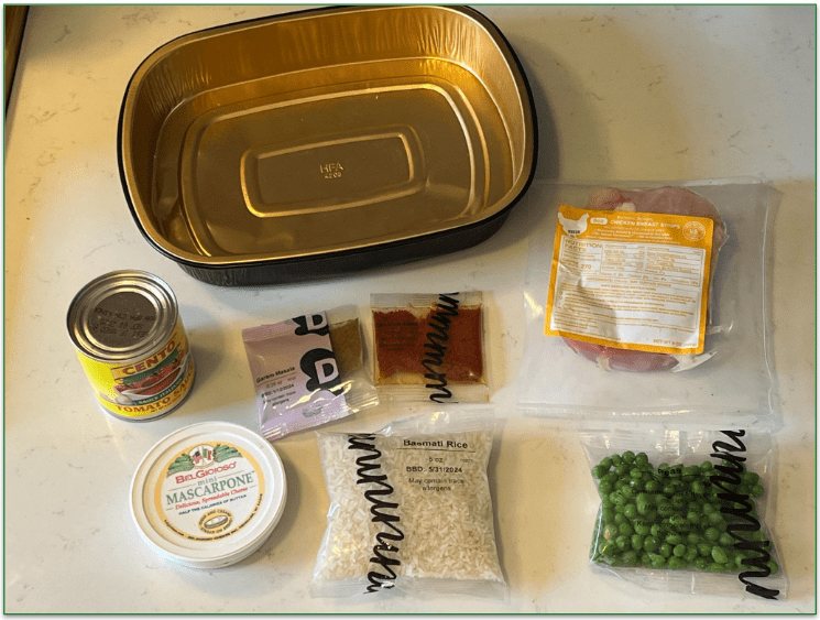 Dinnerly chicken tikka masala ingredients laid out with oven safe tray next to them