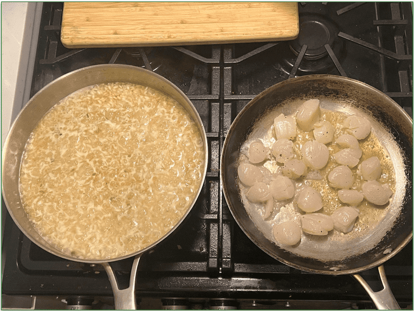 Reviewer cooking seared scallops and garlic herb risotto with scallops in one pan and risotto in another