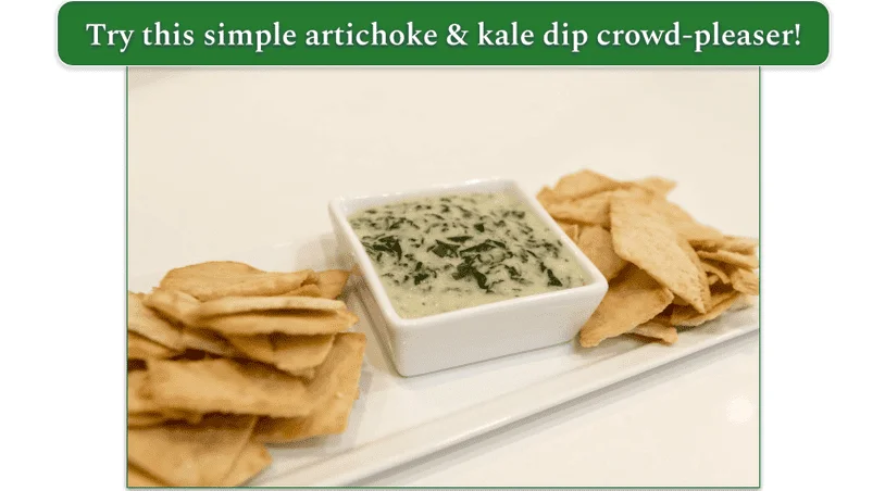 a plate of artichoke and kale dip with a side of pita bread on a plate