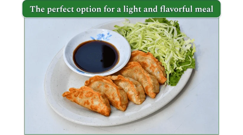 Pot Sticker dumplings on a plate with garnish and dipping sauce
