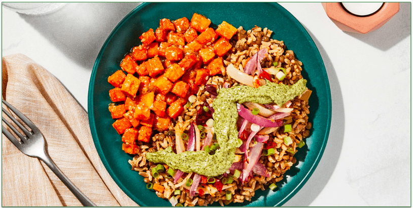 A vegan plate of lentils, rice, and roasted carrots