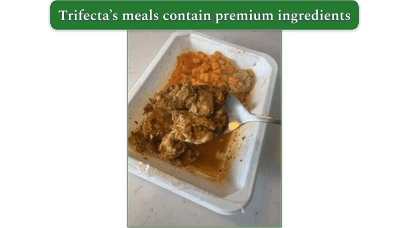 Closeup on a piece of chicken from a Trifecta dish