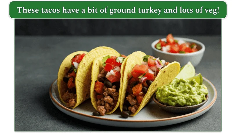 3 tacos on a plate beside some guacamole.