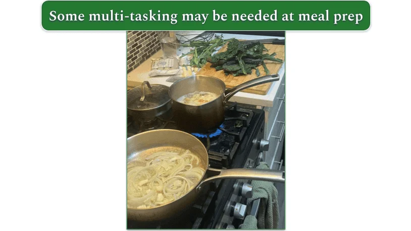 An image showing 3 saucepans on a stove and chopped vegetables