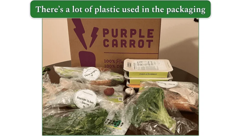 Image of an unboxed Purple Carrot order showing individually wrapped ingredients in plastic