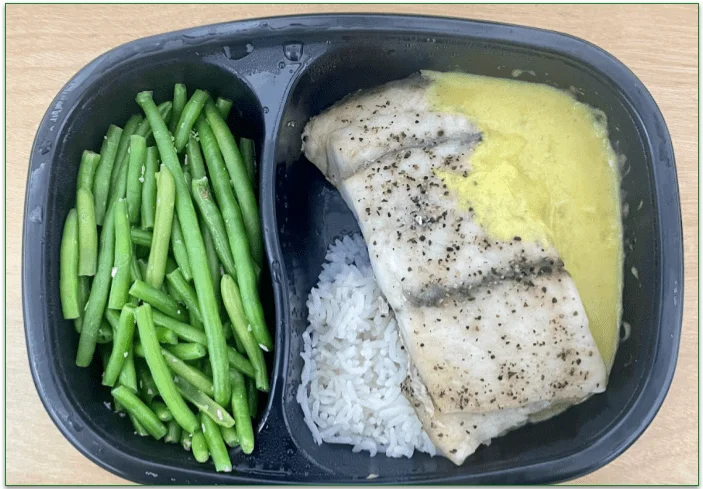 Photo of BistroMD's Barramundi Seabass with Sweet Coconut Pineapple Sauce heated in a microwaveable tray