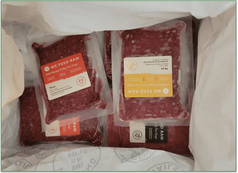 Open We Feed Raw delivery box with frozen packs