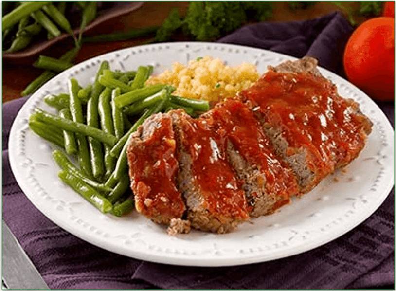 A plate of meatloaf with green beans