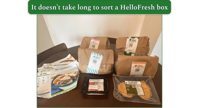 Our reviewers HelloFresh delivery showing 4 large paper bags with recipe cards next to it