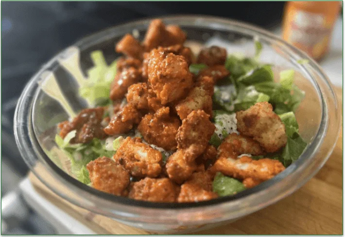 Hungryroot's Crispy Buffalo Chicken Caesar Salad served in a bowl