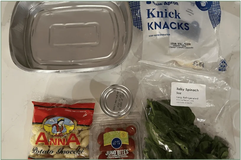 Photo of the ingredients for a Blue Apron Ready to Cook meal with the aluminum tray the ingredients are assembled in for cooking