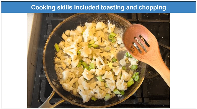 Photo of cauliflower florets and chopped leeks being stirred in a pan on the stove