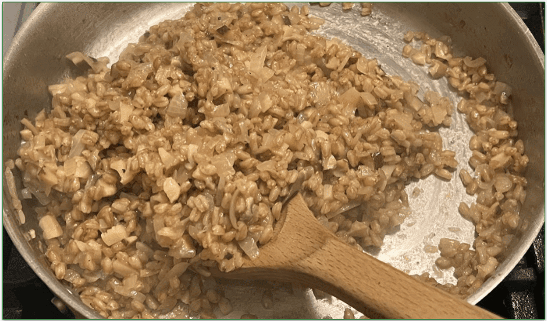 Photo of a risotto being stirred in a pan on the stove