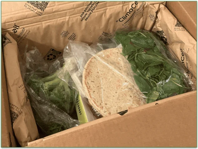 Open Purple Carrot box with ingredients