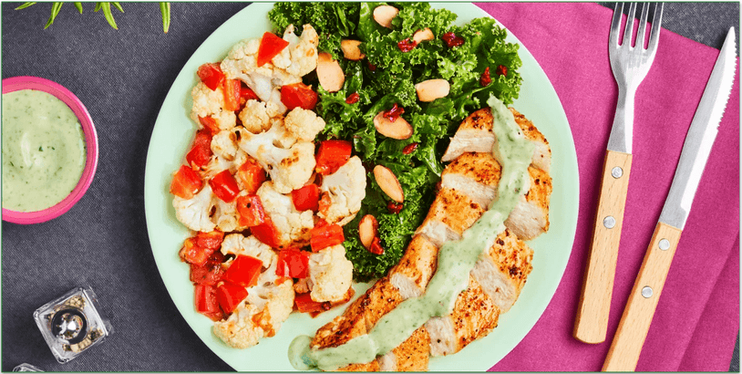 A plate of chicken, cauliflower, and kale salad