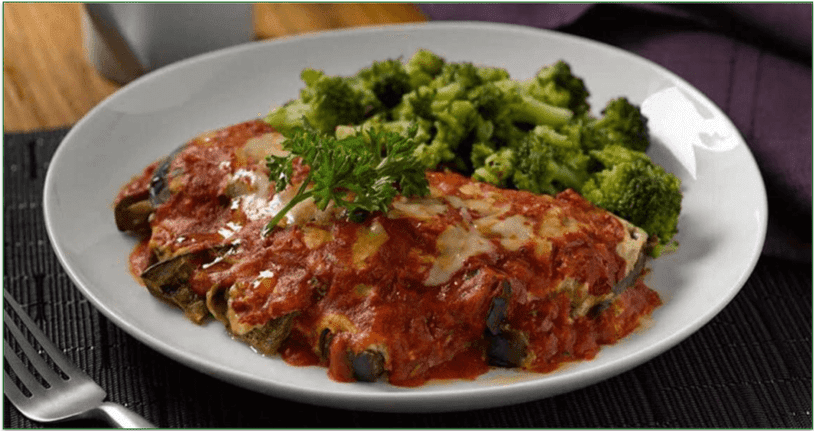 a plate of eggplant lasagna with broccoli