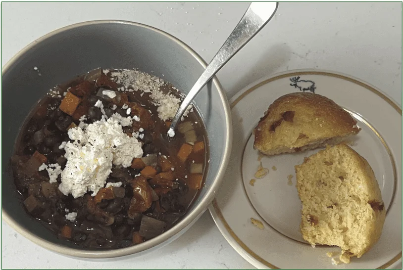 Diet-to-Go's Black Bean Chili dish served in a bowl with cornbread