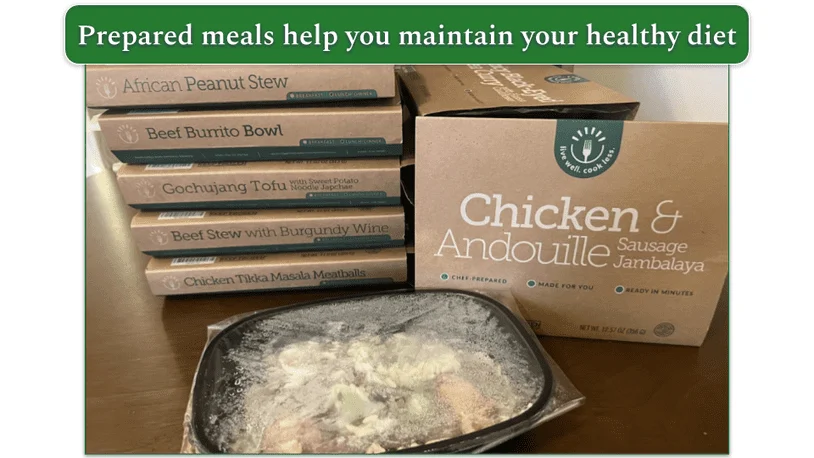Photo of a stack of BistroMD's prepared frozen meals and one frozen meal out of the cardboard packaging in its microwaveable tray