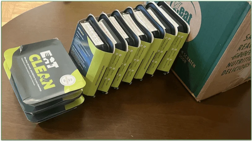 photo of 10 boxed prepared meals displayed next to Eat Clean's delivery box on a table