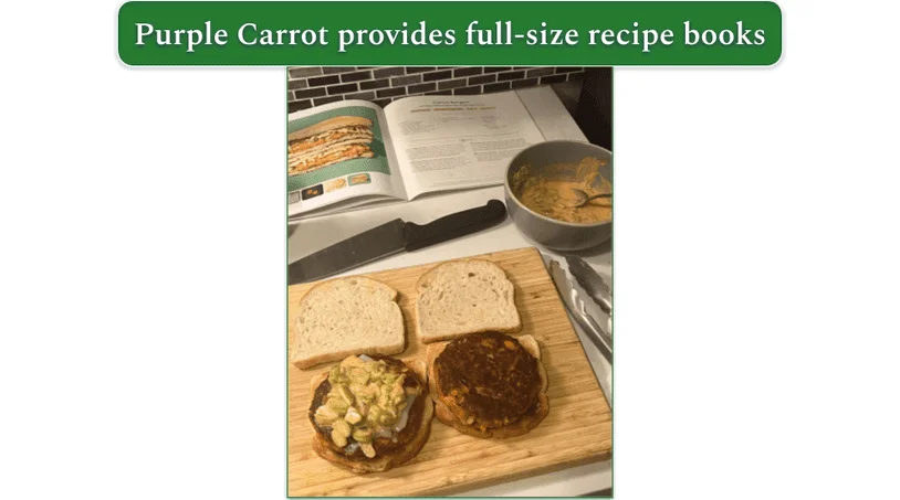 A kitchen counter with a cutting board, mixing bowl, and recipe book