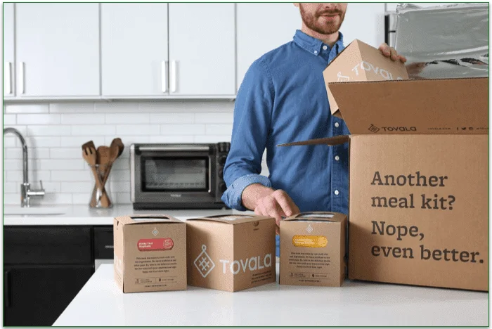 Man unpacking his Tovala delivery on a counter