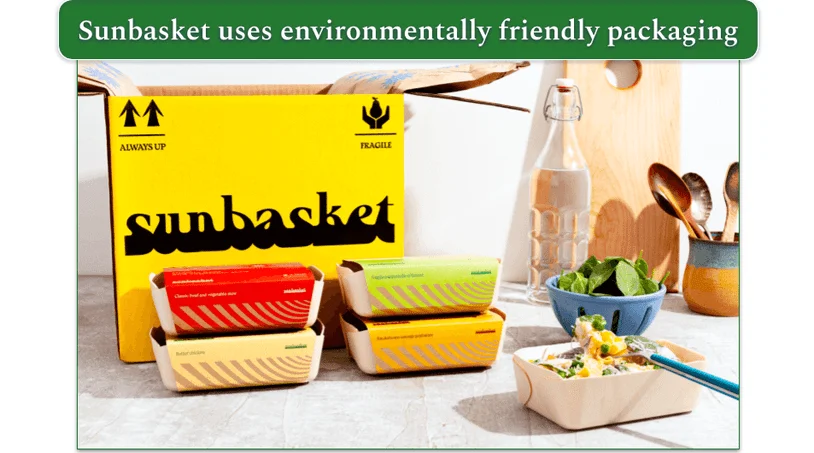 An open Sunbasket box with four Sunbasket entrees in front of it.