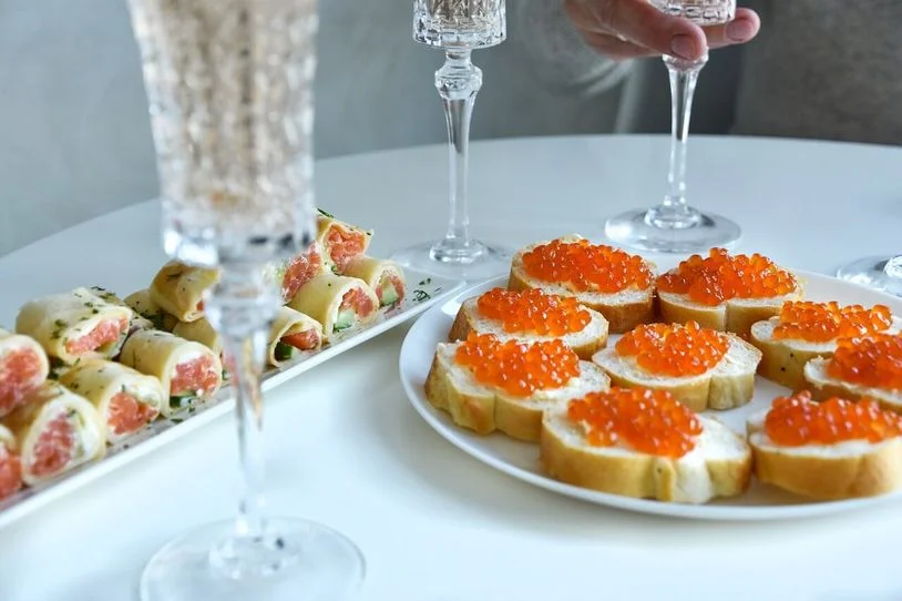 Caviar served on bread and in a roll, on an elegant table