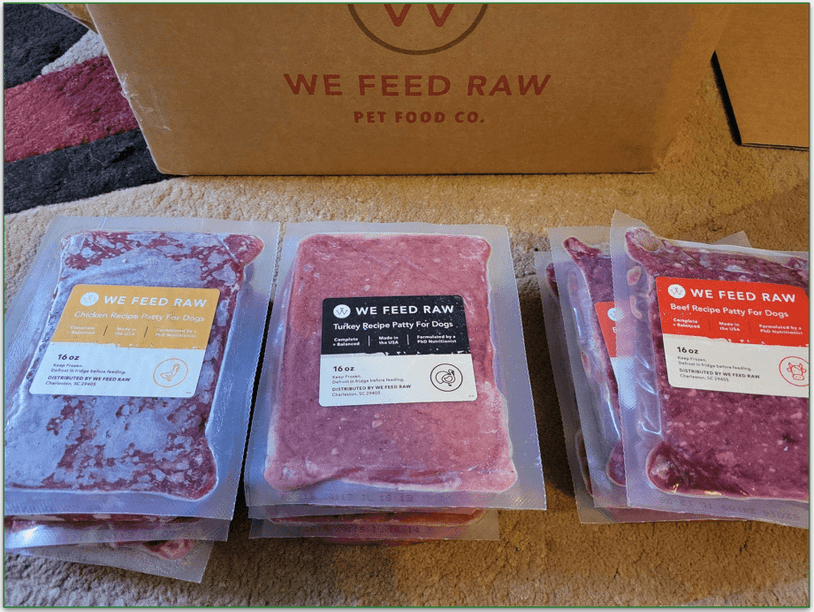 We Feed Raw packages unboxed showing turkey, chicken, and beef