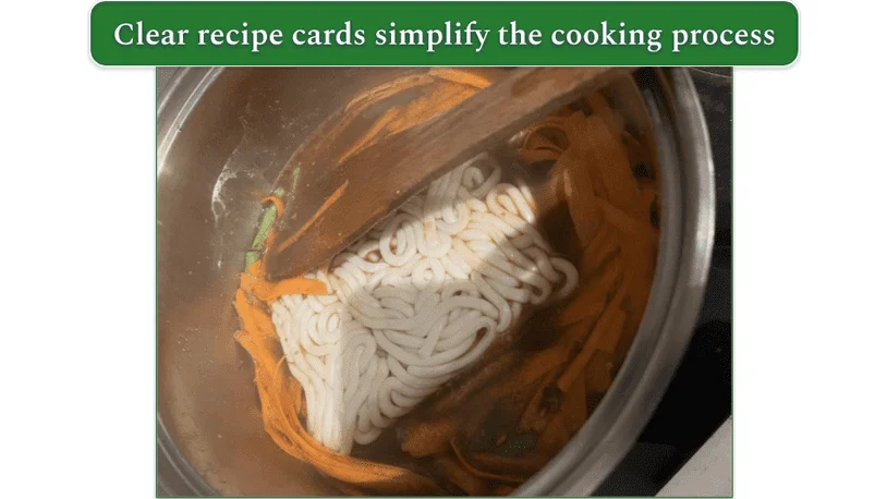 Image from our reviewer of a pot containing carrots, noodles, and broth whilst making miso noodles