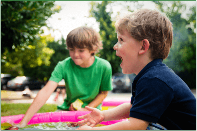 2 children playing at a park.