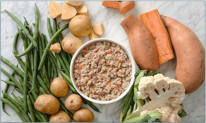 A bowl of TFD's pork recipe surrounded by fresh ingredients