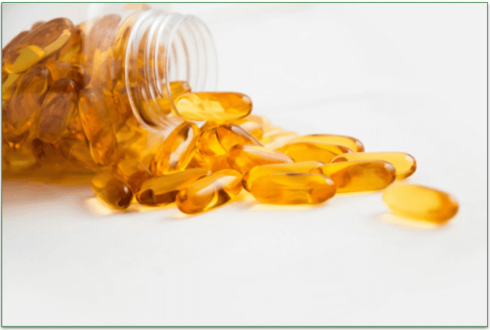 A bunch of omega-6 supplement pills spilling out of a bottle.