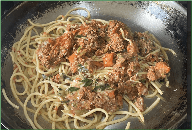 Photo of the Lamb Ragu dish being heated in a skillet on the stovetop