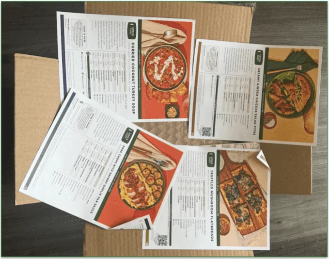 Green Chef's recipe cards displayed on top of a package