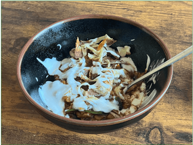 Reviewers image of red lentil soup topped with parsnip ribbons