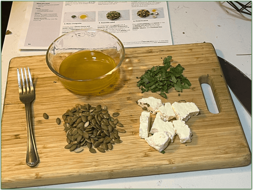 A Marley Spoon recipe card with a bowl of vinaigrette and chopped ingredients in front of it