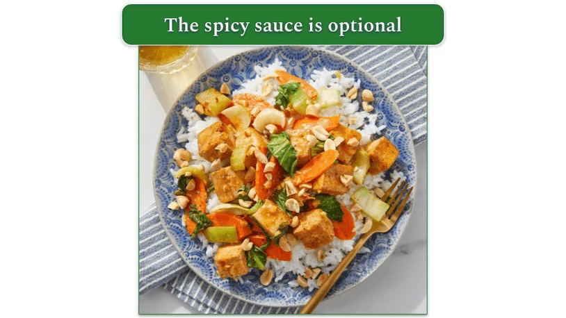 Blue Apron stir-fried tofu and vegetables with spicy sesame peanut sauce on a blue plate