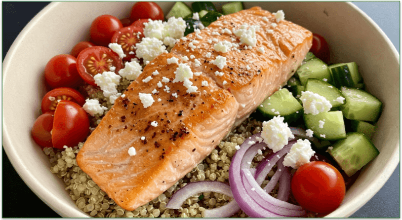 A bowl of quinoa, grilled salmon, and mixed veggies.