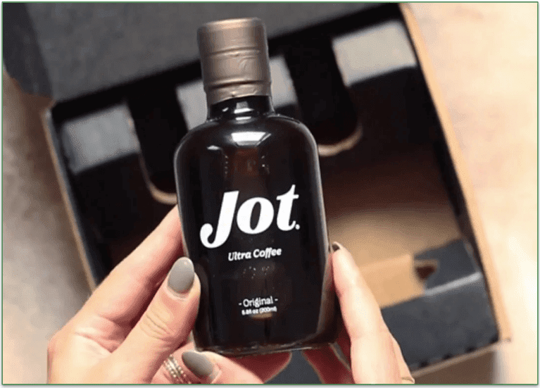 Image of Jot Ultra Coffee glass bottle being held above an open Jot delivery box