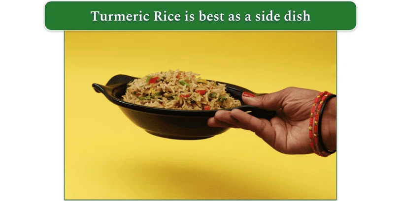 A bowl of Turmeric Rice being placed on a surface